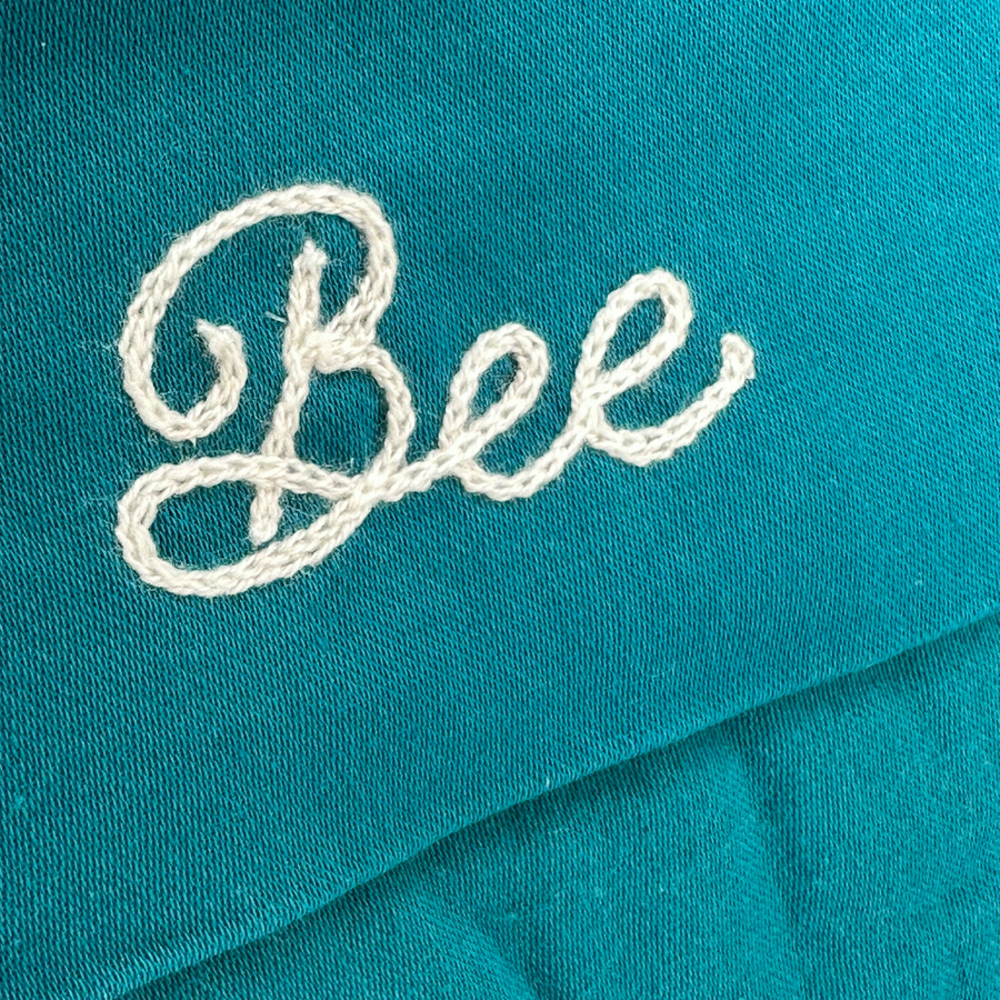 white chainstitching on teal stocking