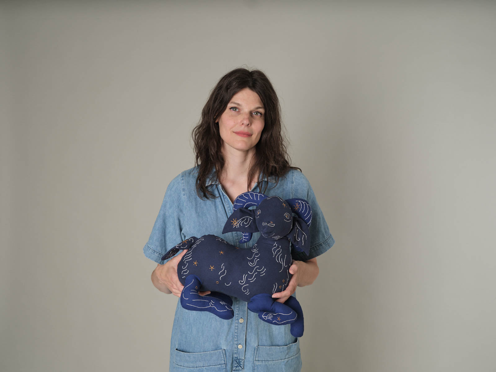 Emily, founder of Haptic Lab, holding the Aries Star Stuff-ie