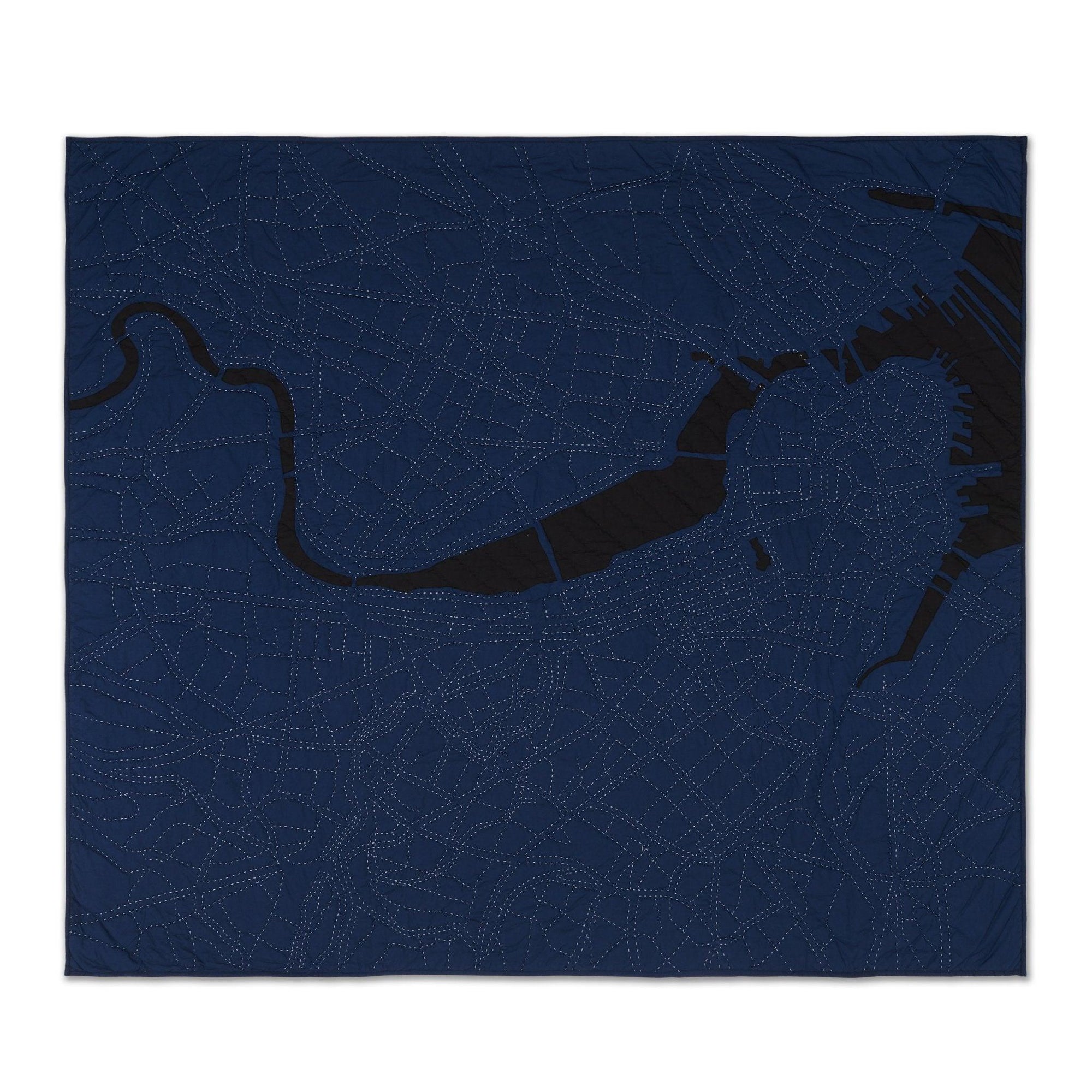 Hand-stitched quilt map of Boston by Haptic Lab with dark blue land and thread tracing city streets.