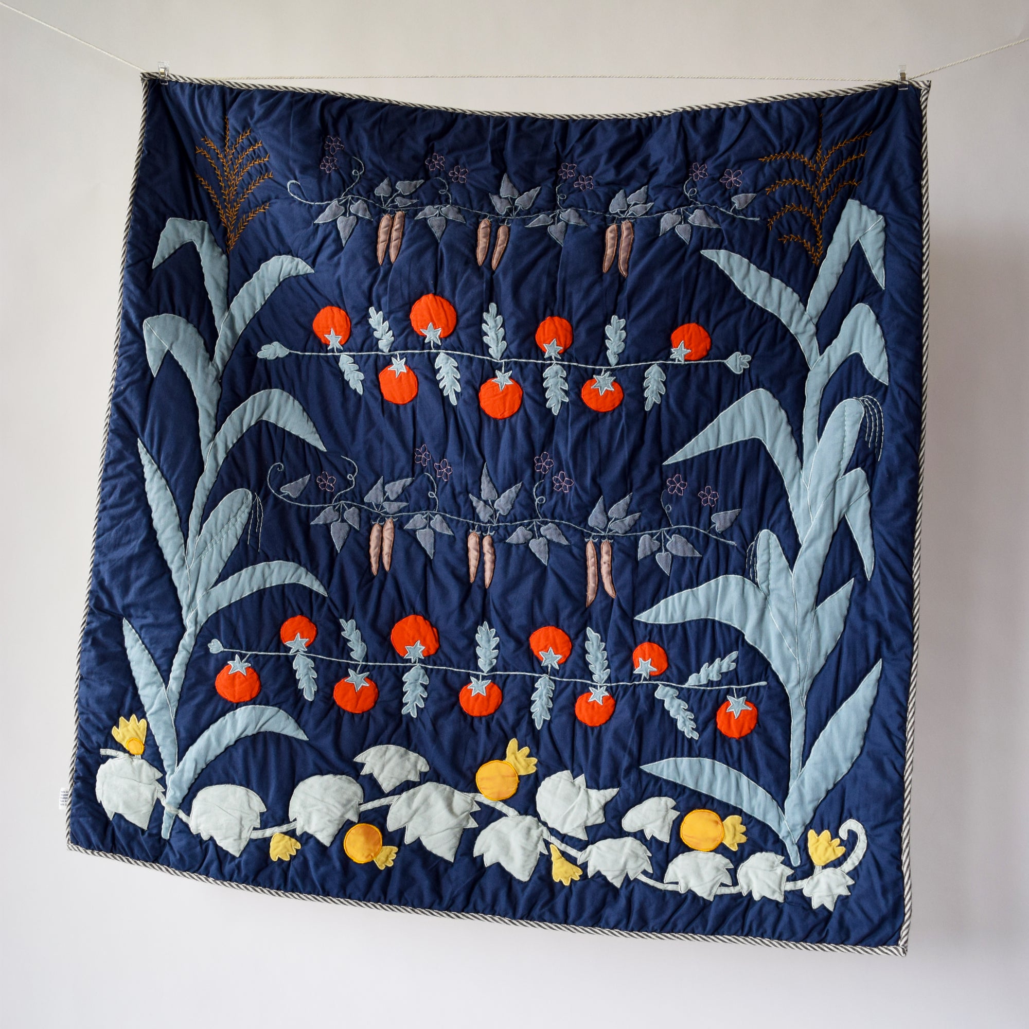 Decorative quilt with vegetable patterns on a plain background