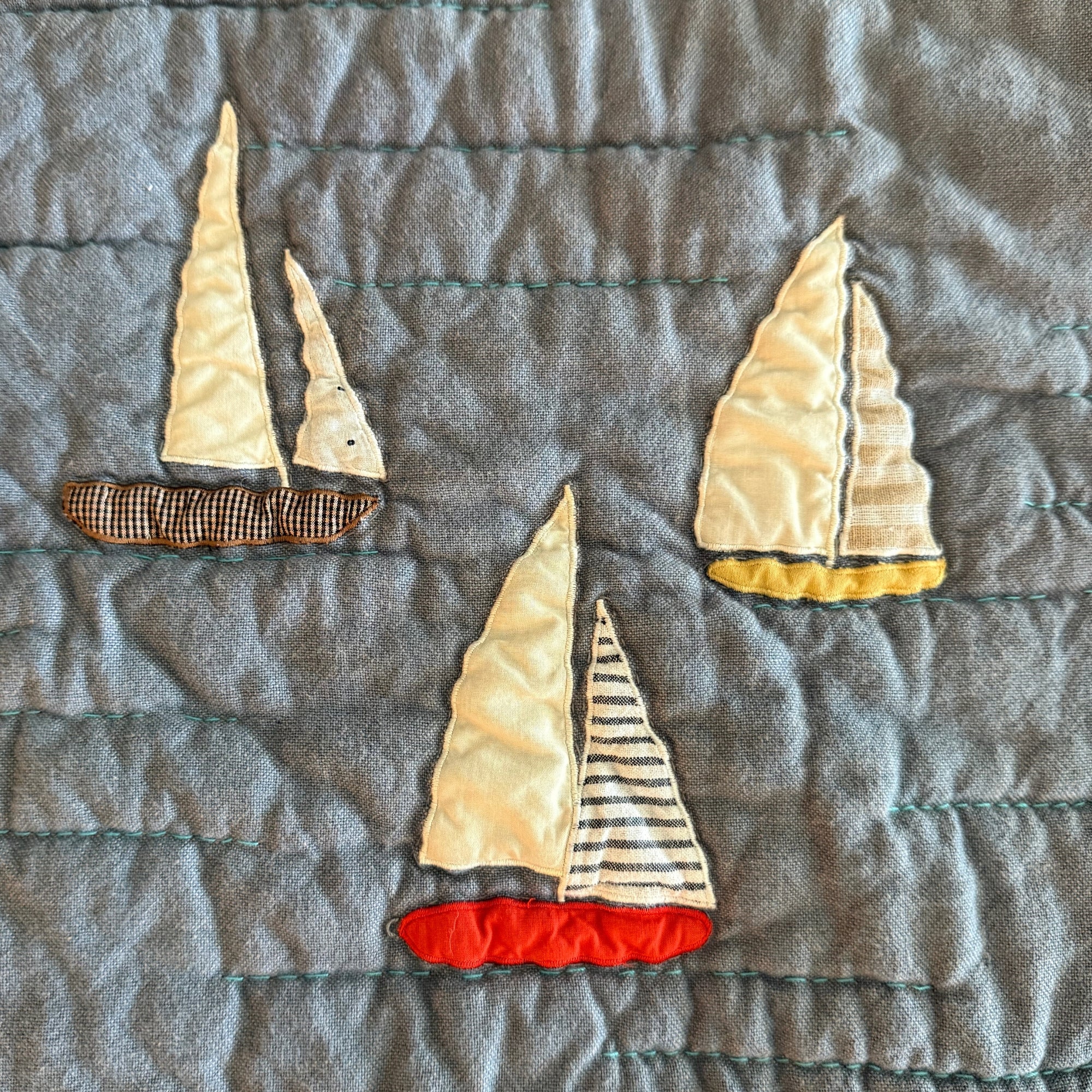 Appliqued sailboats using deadstock fabrics 