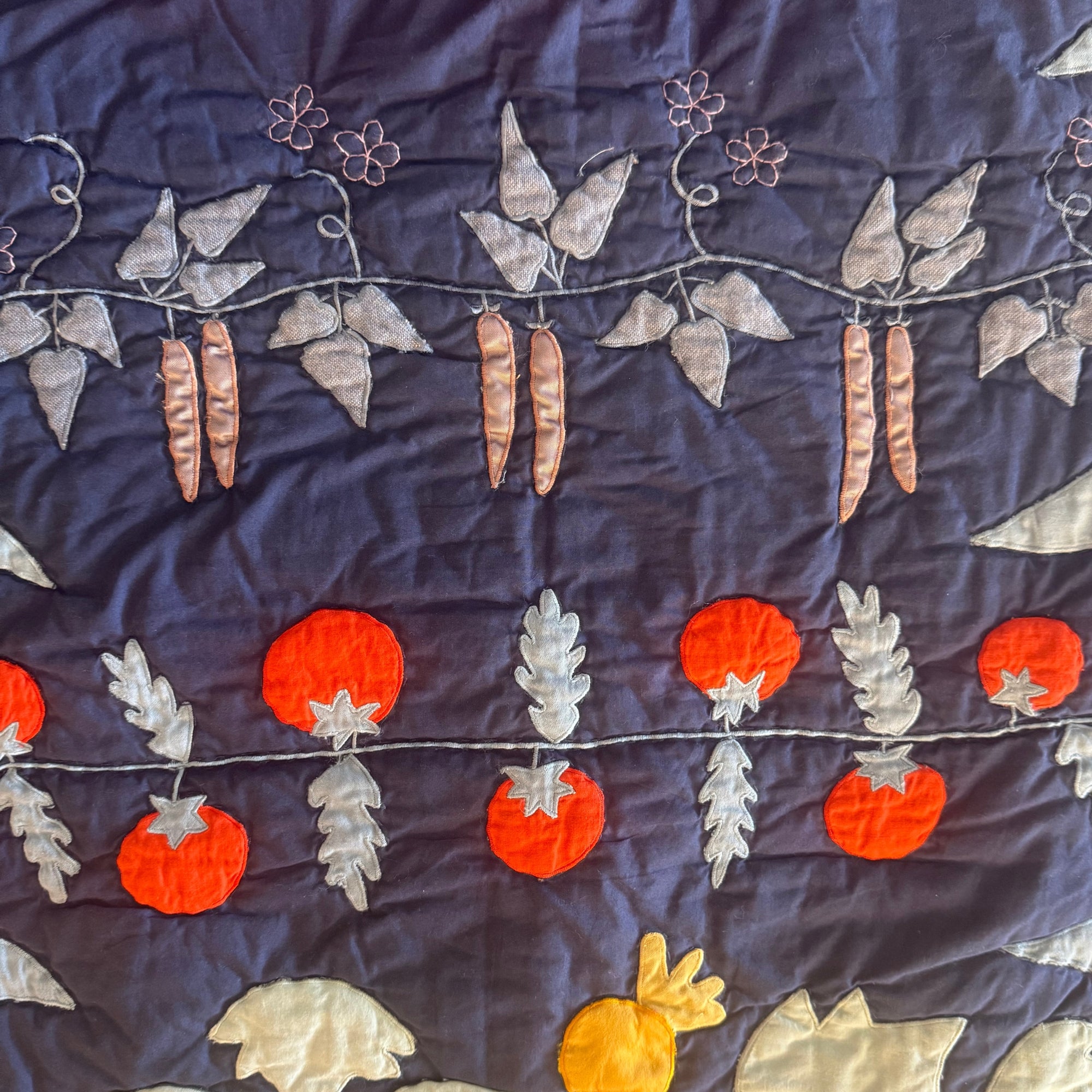 Tomatoes and sweet peas appliqued on Haptic Lab Garden quilt