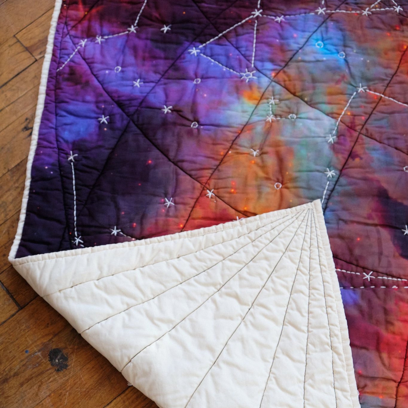 Galileo quilt with corner turned up_ back of quilt is ivory