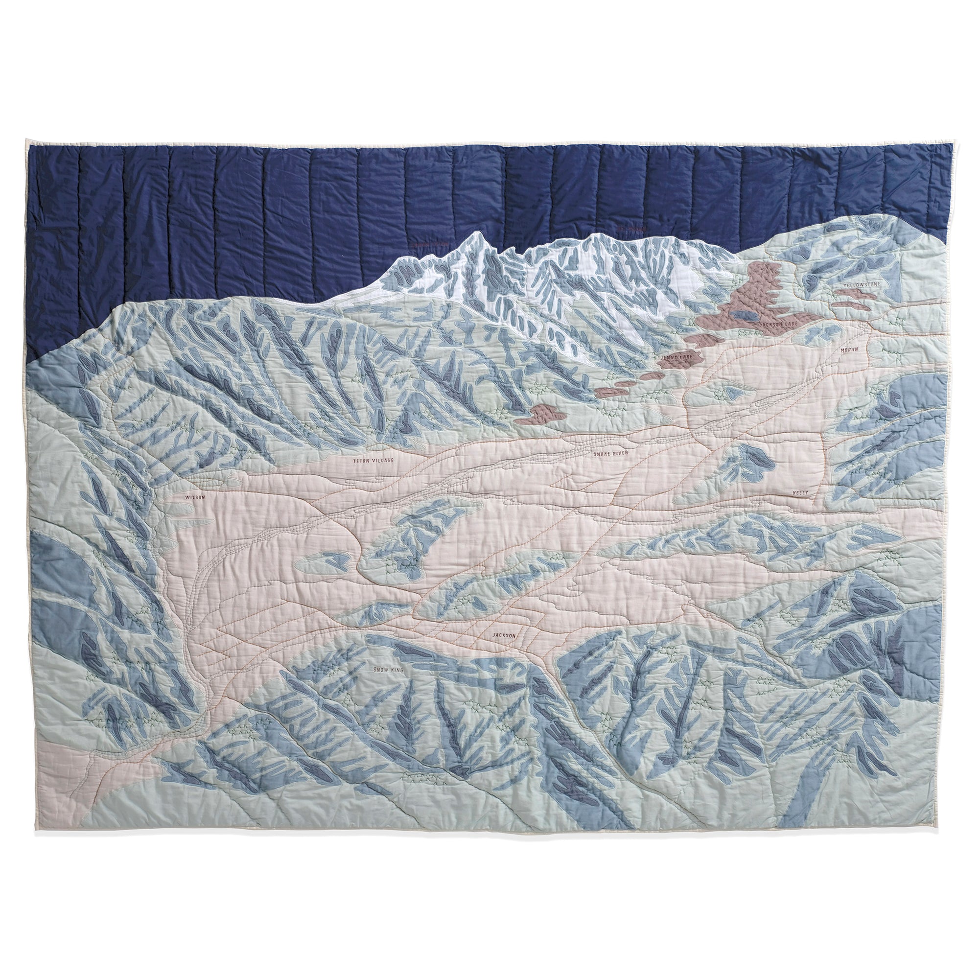 Quilt with Jackson Hole mountain landscape design on a white background
