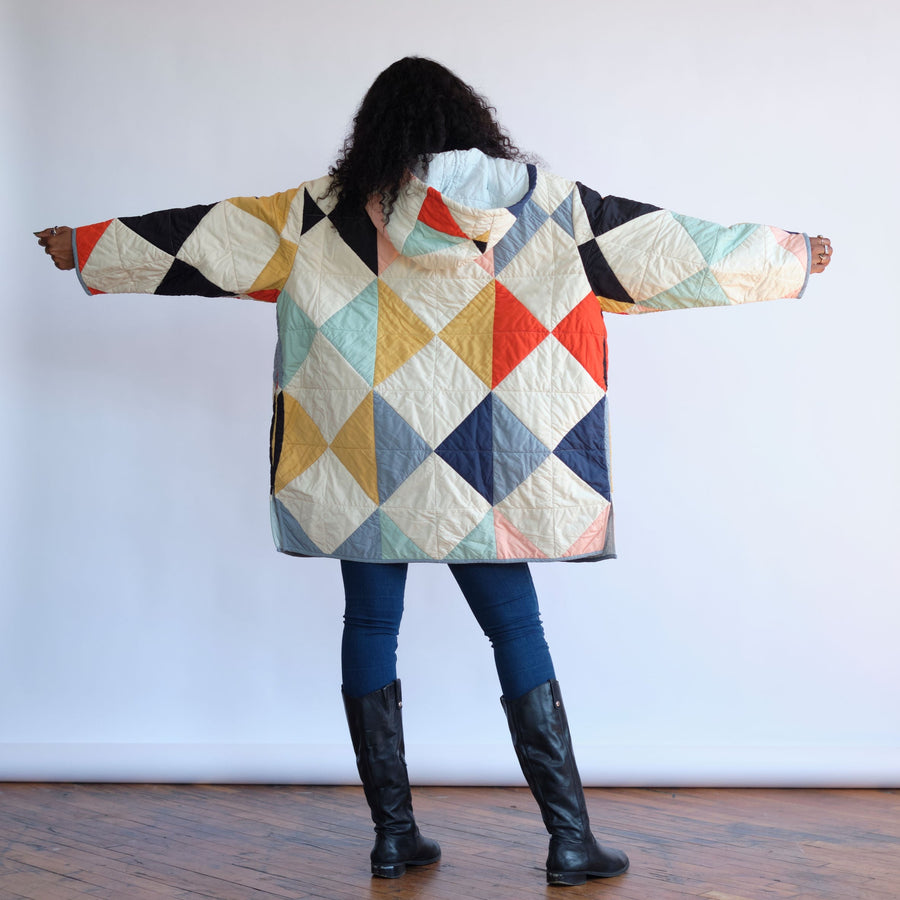 Back of the Harlequin Quilt Coat.  Ivory quilt coat coat with multicolored diamond patchwork. Quilt Coat by Haptic Lab