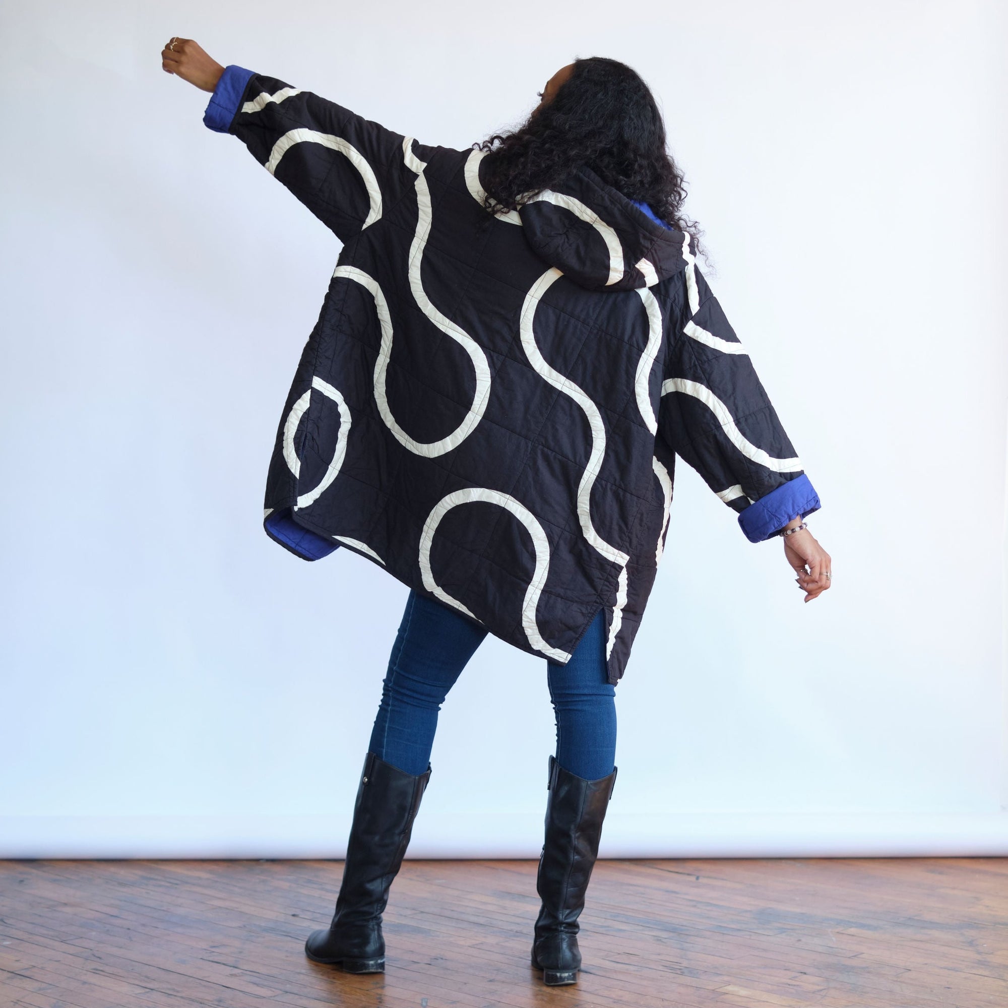 Back of the Snake Path quilt coat. Black coat with white patchwork design