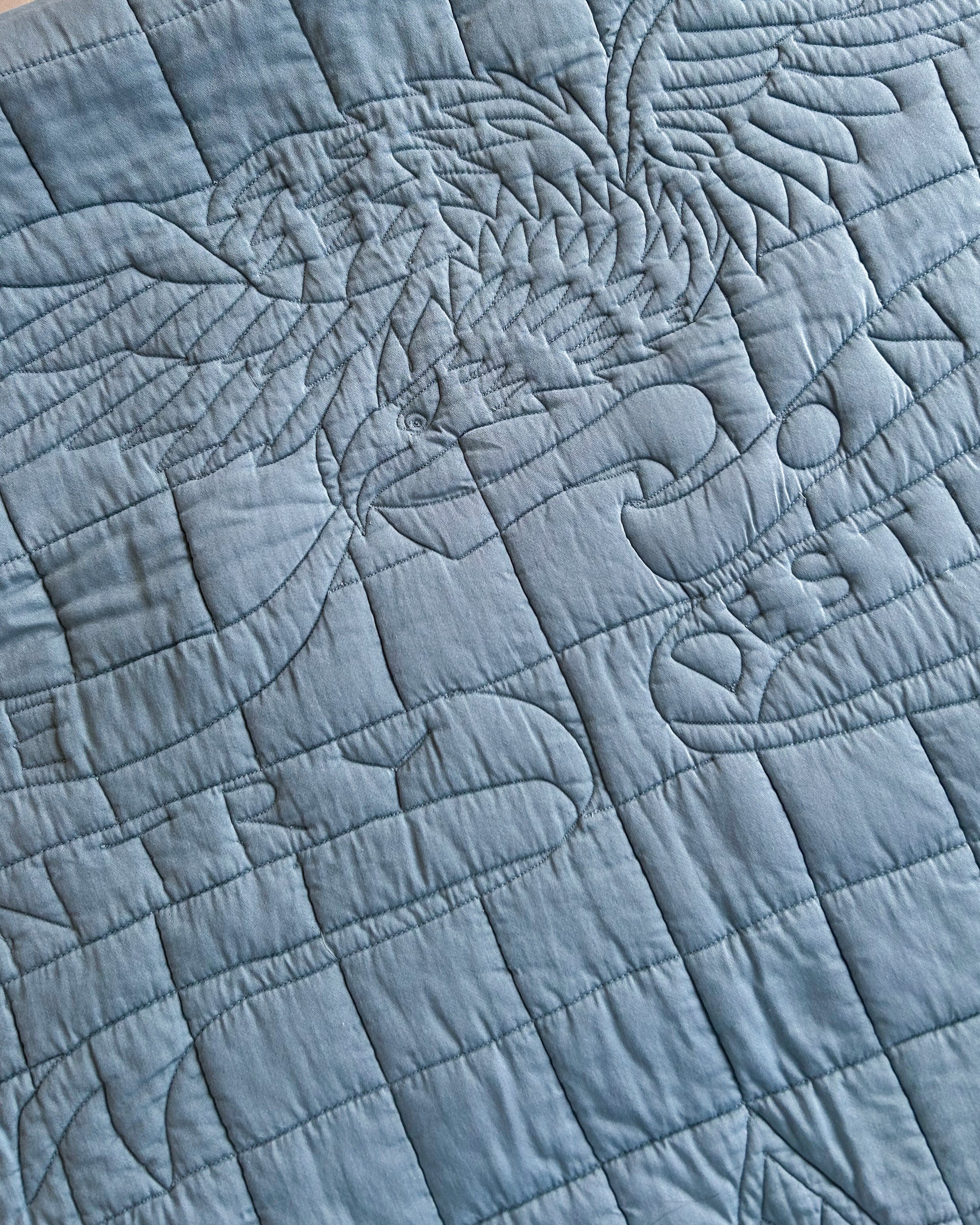 Close-up of quilted blue fabric with an American eagle