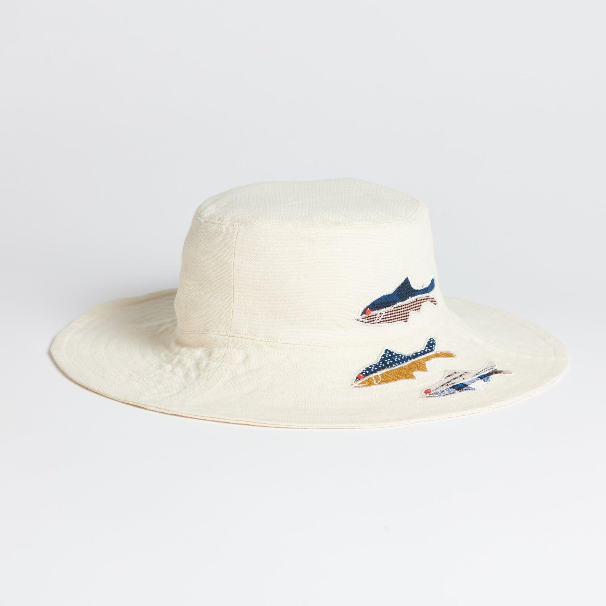 White Sun hat on white background. 3 Fish are appliqued in patterned remnant fabrics. 