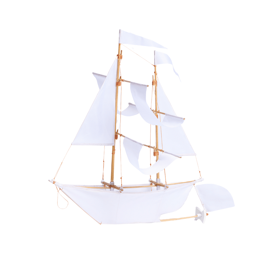 Mini white sailing ship baby mobile shown with white sails and bamboo masts by Haptic Lab.